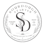 A circular black and white logo for Sourdough Starter, featuring a large stylized 'SD' monogram with leaf details, decorative wreath elements, and text reading 'Sourdough Starter,' 'Organic Pure Alive,' and 'From My Kitchen to Yours' with the website orgsourdoughstarter.com.